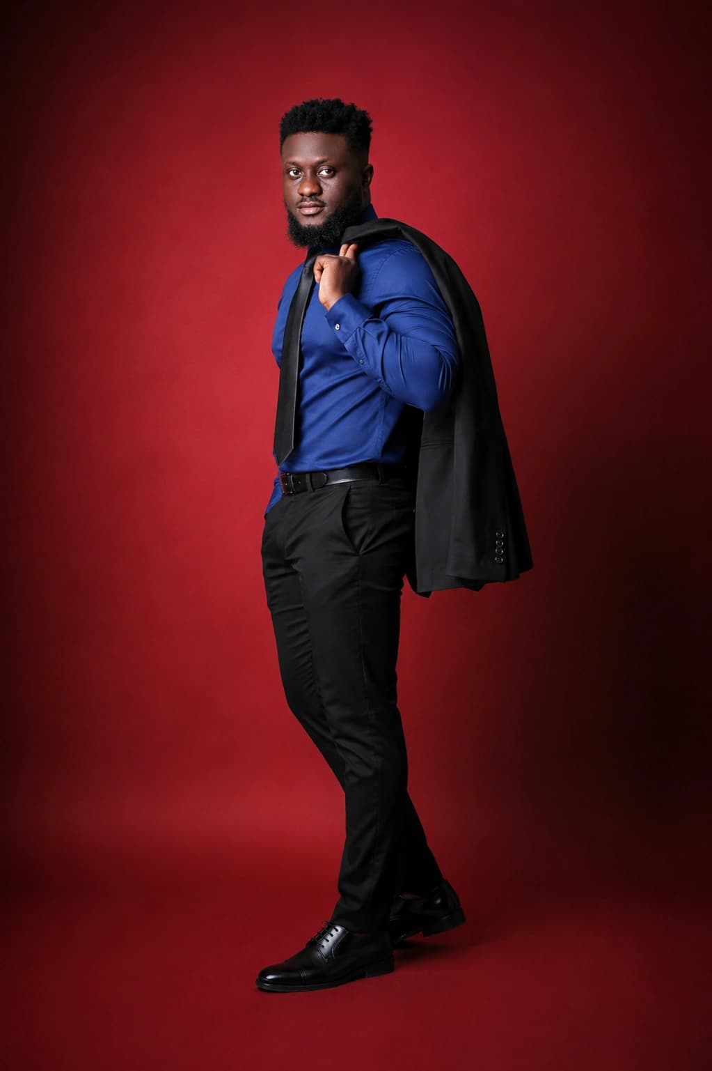 Ahn-TiYe in blue against a red studio background