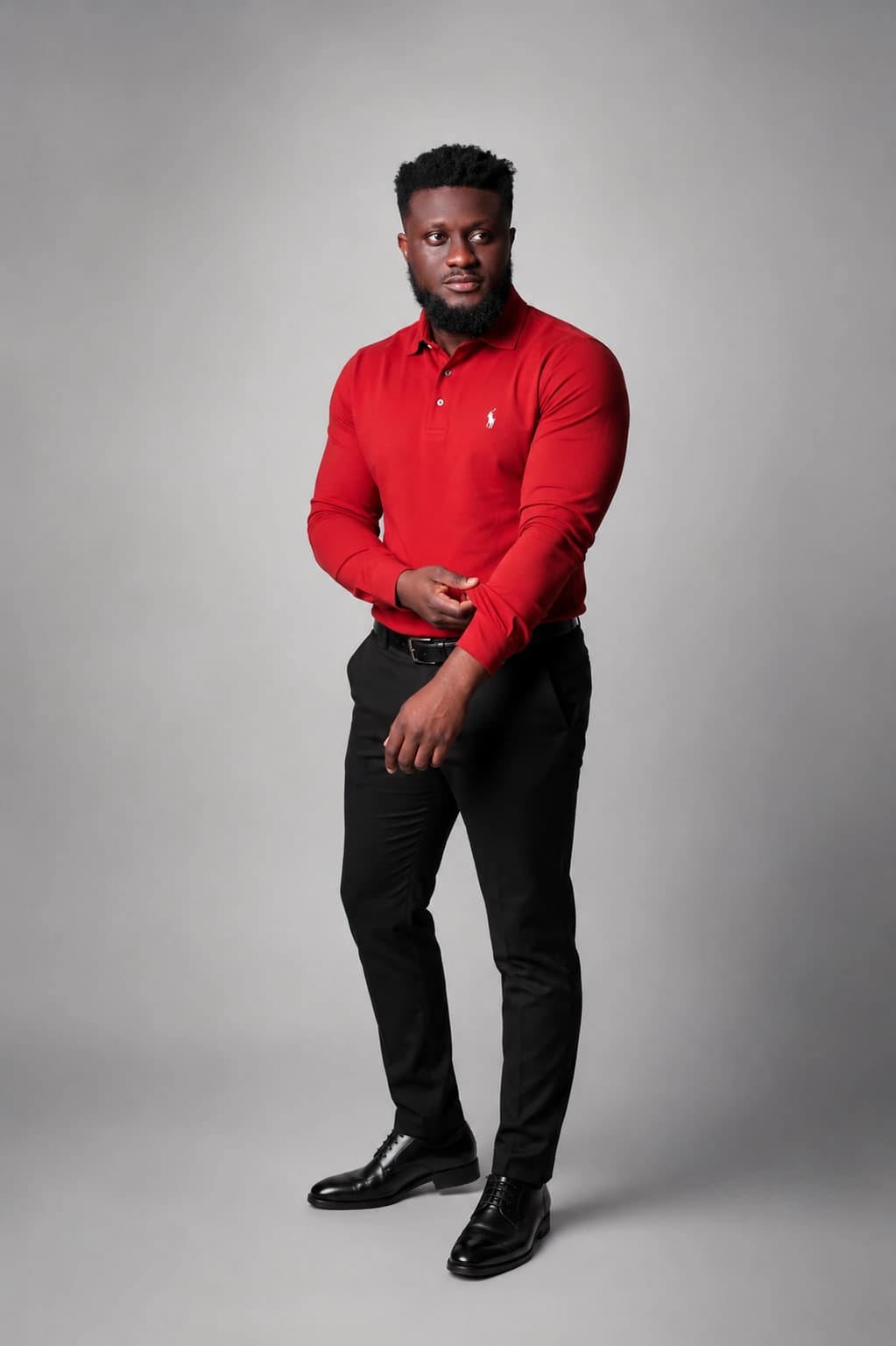 Ahn-TiYe standing in a red polo shirt and black trousers